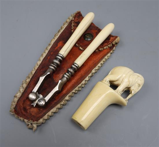 An ivory elephant cane top and a pair of ivory handled nutcrackers